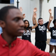 Protesters raise their arms and shout “Hands up, don’t shoot’ outside the James Lawrence King Federal Justice Building, where the U.S. Attorneys Office, Southern District of Florida, is located, on Aug. 14, 2014, in Miami. The protesters included members of the civil rights group Dream Defenders. (Joe Raedle/Getty Images)